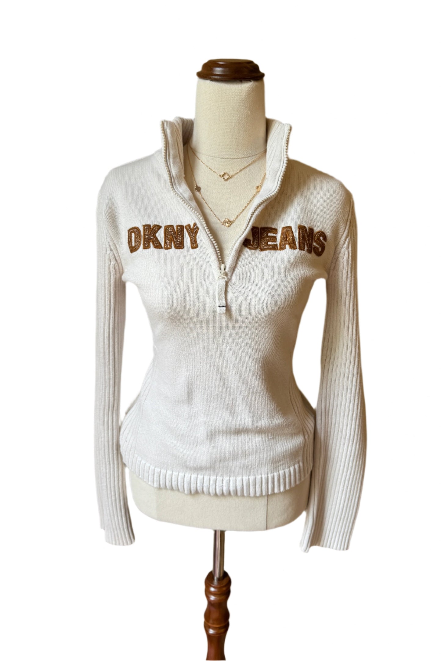 white DKNY quarter zip sweater